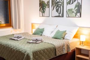 a bedroom with a bed with two pillows on it at Lipno Stories in Lipno nad Vltavou