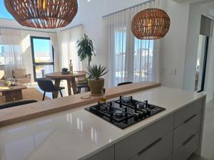 a kitchen with a stove top on a counter at Yzer Heights Relaxed Luxury Stay in Yzerfontein