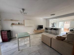 a living room with a couch and a table at Casa Familiar Atarfe in Atarfe