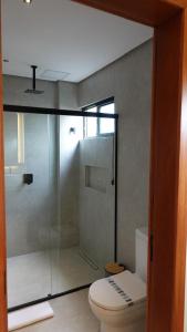 a bathroom with a toilet and a glass shower at Be Caju Hotel in Barra Grande +11 photos