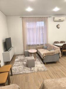 un soggiorno con un divano e una TV di Светлый уголок a Yerevan