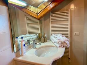 a bathroom with a sink and a mirror at Al Castello B&B in Eboli +13 photos