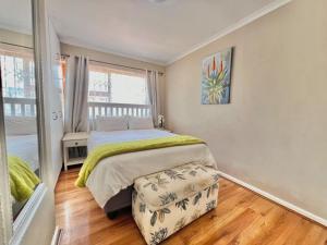 a bedroom with a bed and a large window at Princess Holiday Home in Cape Town