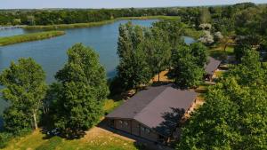 an aerial view of a building next to a river at Siocamping Házak Homes in Siófok