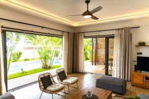 a living room with a large sliding glass door at Summer Palms Villa in Flic-en-Flac