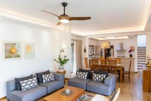 a living room with a couch and a table at Summer Palms Villa in Flic-en-Flac