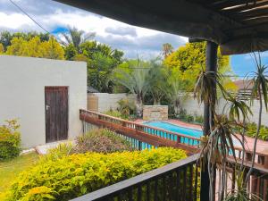 a house with a fence and a swimming pool at Princess Holiday Home in Cape Town