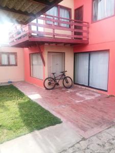 uma bicicleta estacionada na lateral de um prédio em Playas de Quintero em Quintero mais 3 fotografias