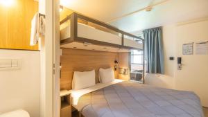 a bedroom with a bunk bed in a room at Premiere Classe Bayonne in Bayonne