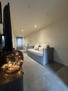 a large living room with a couch and a table at Le petit cocon in Sens