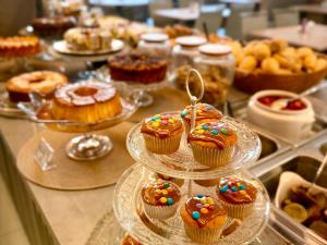 a display of cupcakes and other desserts on a counter at Pousada Duas Ilhas in Penha