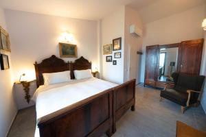 a bedroom with a large bed and a chair at Uliveto Moriondo in Salò +27 photos