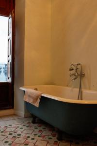a bathroom with an old fashioned tub in a room at La Casa del Médico in Pego +17 photos
