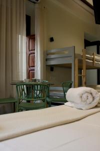 a bedroom with a bed with a towel on the bed at La Casa del Médico in Pego