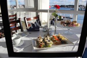 a table with a plate of food on top of it at Hummeren Hotel in Tananger