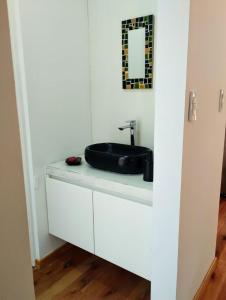 a bathroom with a sink on a white cabinet at Big Sur in Mar Azul
