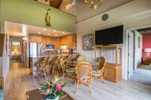 eine Küche und ein Esszimmer mit einer Bar mit Stühlen in der Unterkunft Papakea E407 in Kahana