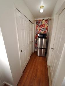 a hallway with a door and a refrigerator at Abiel Global Concepts LLC in Newark +25 photos