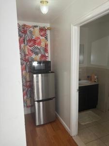 a kitchen with a stainless steel refrigerator in a room at Abiel Global Concepts LLC in Newark