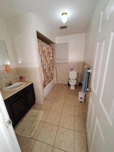 a bathroom with a toilet and a sink at Abiel Global Concepts LLC in Newark