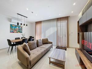 a living room with a couch and a table at Malta Rooftop Villa with Private Plunge Pool & BBQ in Hal Ghaxiak