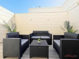 a patio with wicker chairs and a table at Malta Rooftop Villa with Private Plunge Pool & BBQ in Hal Ghaxiak +26 photos