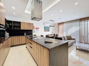 a kitchen with a large island in a living room at Malta Rooftop Villa with Private Plunge Pool & BBQ in Hal Ghaxiak
