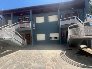 a blue building with stairs on the side of it at Apart Hotel Posta Marina in San Antonio Oeste