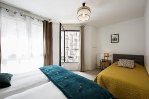 Una cama o camas en una habitación de MAISON SAINT CHARLES - ASSOCIATION HABITAT et HUMANISME ILE DE FRANCE 31 fotos más