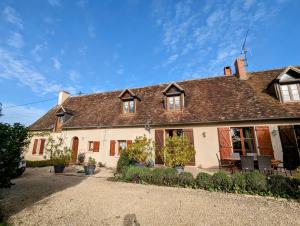 a large white house with a brown roof at Domaine de la Botterie, Jaune in Azay-le-Ferron