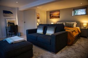 a living room with a couch and a bed at 1 Bedroom studio with free parking in Truro