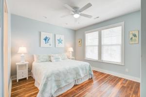 a bedroom with a bed and a ceiling fan at LaiDDback in Folly Beach
