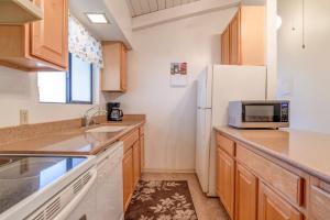 a kitchen with a sink and a refrigerator at Hono Kai C12 in Maalaea