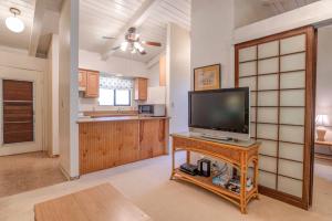 a living room with a television on a table at Hono Kai C12 in Maalaea