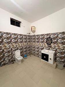 a bathroom with a toilet and a sink at Retrova - Forest Villa near Rajpur Road in Rājpur