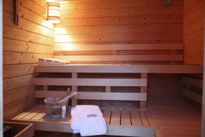 a sauna with a bench and a bucket in it at Kembser Kate - Ostholstein - NEU! in Behrensdorf +15 photos