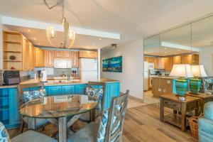 a kitchen and living room with a table and chairs at Kahana Reef 321 in Kahana +23 photos