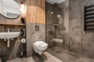 a bathroom with a toilet and a sink and a shower at EIR Apartments by Heimaleiga in Reykjavík