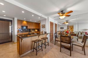 una cucina con bar, sedie e tavolo di Valley Isle Resort 1105 a Kahana