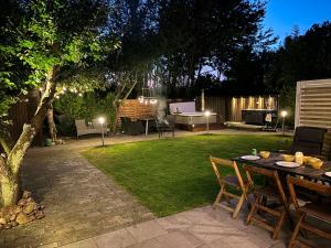 a patio with a table and chairs in a yard at Hambo Stay in Staffanstorp