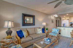a living room with a couch and a table at Kahana Reef 106 in Kahana