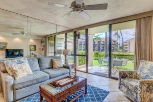 a living room with a couch and a table at Kamaole Sands 2-106 in Wailea