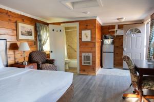 a bedroom with a bed and a desk in a room at Senator Inn & Spa in Augusta