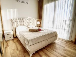 a bedroom with a large bed and a large window at Spacious & Bright 2BR Apartment, 5min to Beach in Boghaz +31 photos
