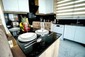 a kitchen with a counter with two plates on it at Spacious & Bright 2BR Apartment, 5min to Beach in Boghaz