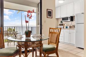 a kitchen and dining room with a table and chairs at Noelani 213 in Kapalua-West Maui Airport