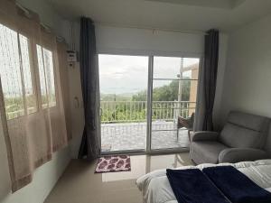 a bedroom with a bed and a window with a view at Mong Do Lay Baan Sea View in Ban Ao Makham