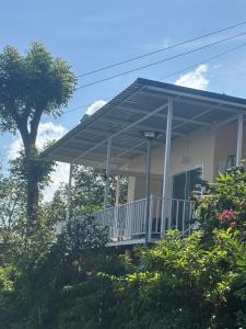 a house with a porch with awning on it at Mong Do Lay Baan Sea View in Ban Ao Makham
