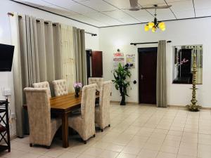 a dining room with a wooden table and chairs at Browns Hill Matara in Matara