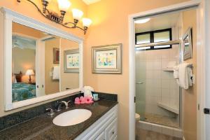 a bathroom with a sink and a mirror at Noelani 113 in Kahana